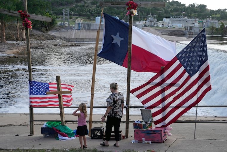 Nancy Epperson, right, and Brooklyn Pucek, 6, visit a memorial for flood victims along the Guadalupe River on Thursday, July 10, 2025, in Kerrville, Texas.