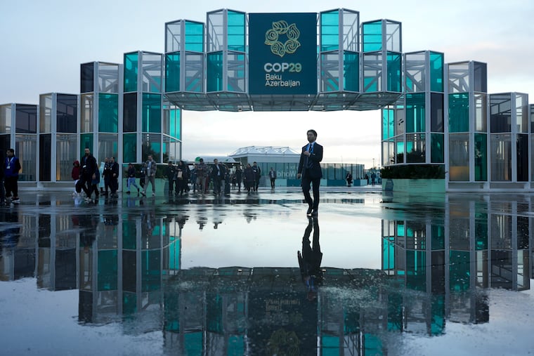 Attendees arrive for the day at the COP29 U.N. Climate Summit, Thursday, Nov. 14, 2024, in Baku, Azerbaijan.