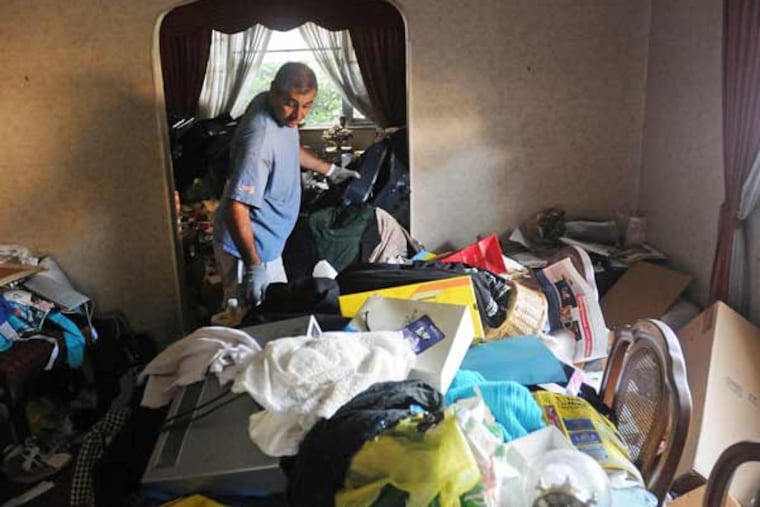 Charlie Castronovo, a real estate agent and investor who bought this house with the intention of renovating and re-selling, cleans out unwanted furniture and household items on Aug. 27, 2014 at a house he and his partner brought in Clifton, N.J. (Mitsu Yasukawa/The Record/MCT)