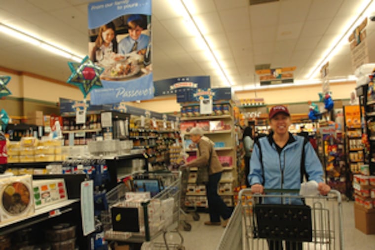 Joan Denenberg of Wynnewood looks over the aisles at the Acme in Narberth for Passover goodies. "We do a spring cleaning before making the meal," she said.
