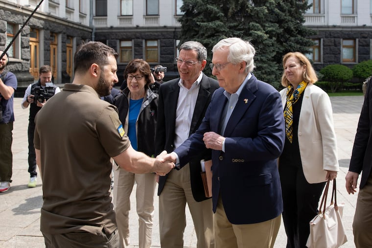 Ukrainian President Volodymyr Zelenskyy, left, shakes hands with Senate Minority Leader Mitch McConnell, R-Ky., in Kyiv, Ukraine.
