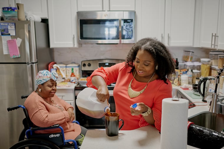 Feylyn Lewis makes a cup of tea for her mother, Darline, who uses a wheelchair since she had a stroke. “I was thrust back into a caregiving role full time,” she says. (William DeShazer for The New York Times)