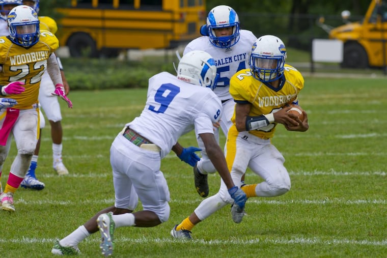 Woodbury’s George Castaldi tries to run around Salem’s Kaciir Street.