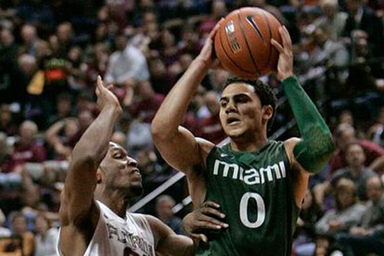 Miami's Shane Larkin gets around the defense of Florida State's Michael Snaer to get a shot off in the second half of an NCAA college basketball game Wednesday, Feb. 13, 2013, in Tallahassee, Fla. Miami held off Florida State to win 74-68. (Steve Cannon/AP)