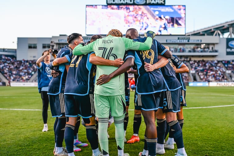 Goalkeeper Andrew Rick (center) in the pregame huddle with teammates before the Union's MLS match against the Chicago Fire at Subaru Park earlier this summer.