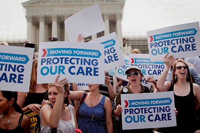 Demonstrators in favor of the Affordable Care Act hold up signs outside the Supreme Court building after the court's ruling in Washington, D.C., U.S., on Thursday, June 28, 2012. The U.S. Supreme Court upheld the core of President Barack Obama's health-care overhaul, giving him an election-year triumph and preserving most of a law that would expand insurance to millions of people and transform an industry that makes up 18 percent of the nation's economy. (Andrew Harrer/Bloomberg)