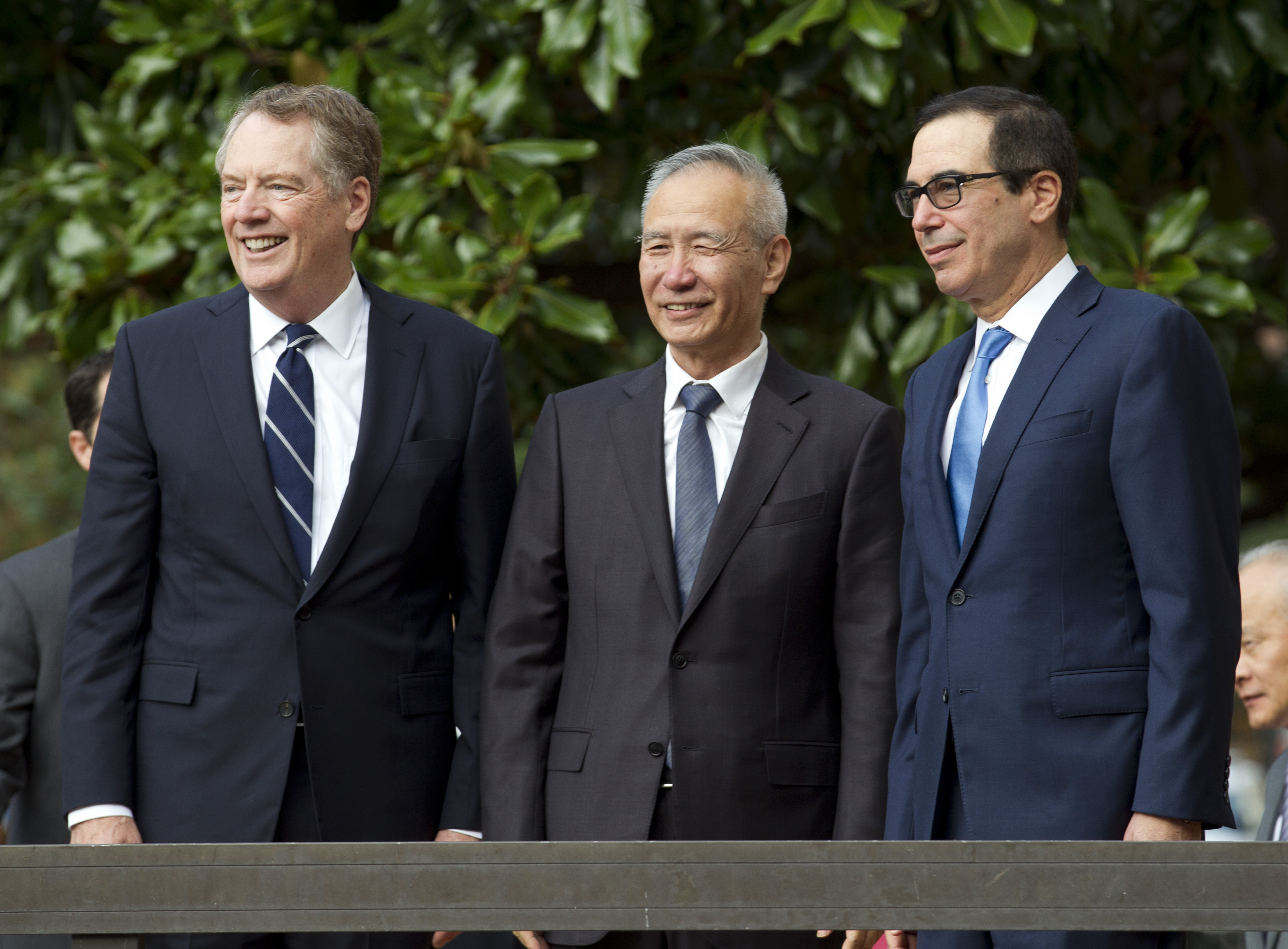 Chinese Vice Premier Liu He accompanied by U.S. Trade Representative Robert Lighthizer, left, and Treasury Secretary Steven Mnuchin, greets the media before a minister-level trade meetings at the Office of the United States Trade Representative in Washington, Thursday, Oct. 10, 2019.