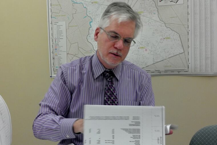 Cherry Hill's Community Development Director Paul Striddick on 11/20/2013 looking over Costco's proposal to build at the old Garden State Park in the township. (MELANIE BURNEY/Staff)