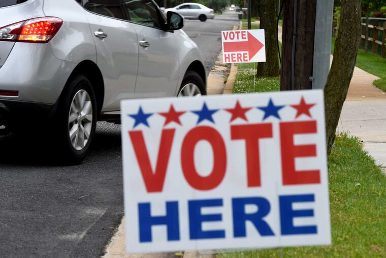 Signs outside the polling place at St. Thomas Greek Orthodox Church June 6, 2017, where Democratic primary voters in Cherry Hill, for the first time in recent memory, have a choice between rival teams of township council candidates: A self-described progressive slate is challenging the incumbents and party regulars for four open seats. TOM GRALISH / Staff Photographer