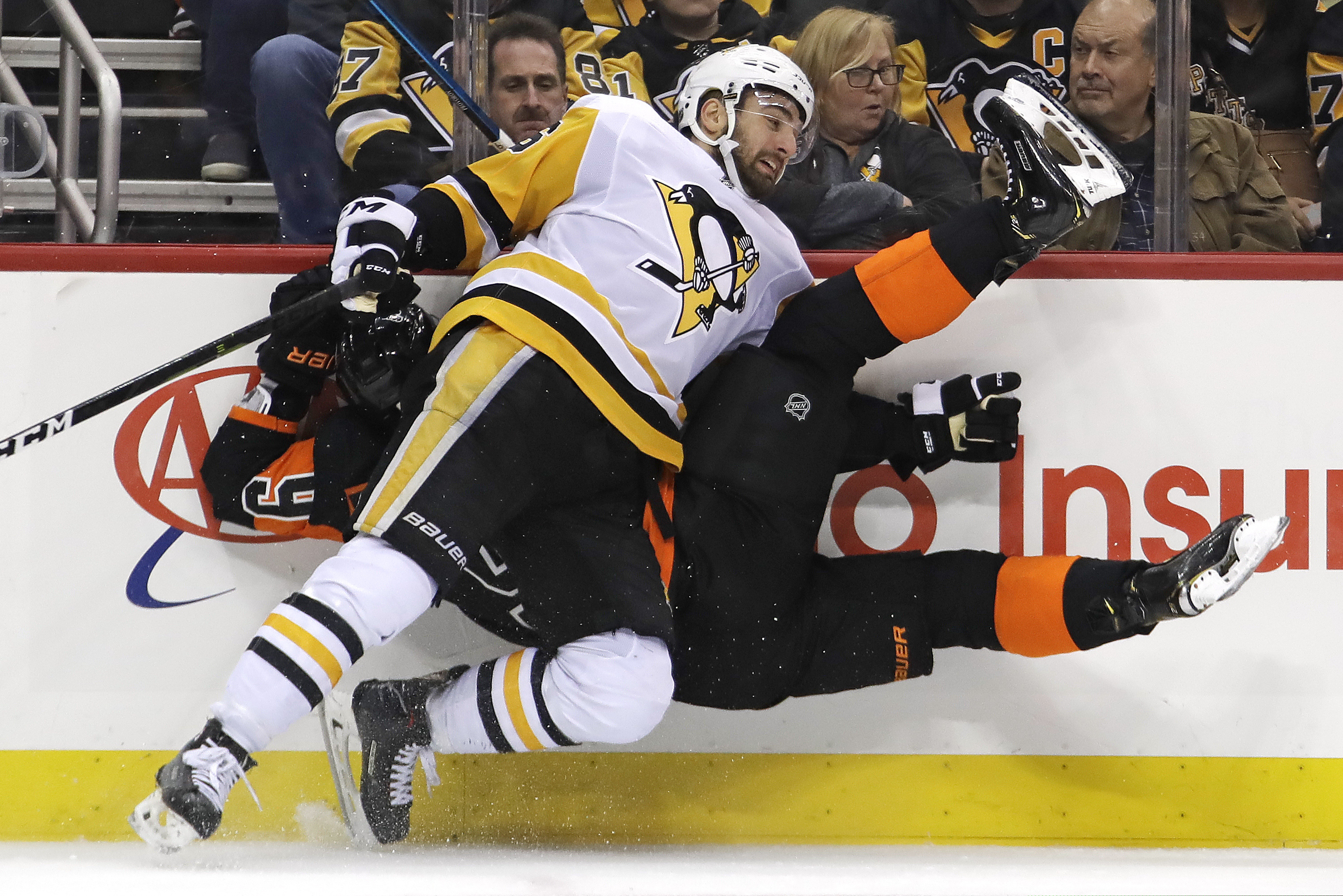 The Flyers' Ivan Provorov (9) colliding with the Penguins' Zach Aston-Reese during the second period Saturday.