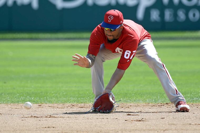 Philadelphia Phillies infielder J.P. Crawford fields a ground ball during batting practice before a spring training baseball game against the Atlanta Braves, Wednesday, March 8, 2017, in Kissimmee, Fla.