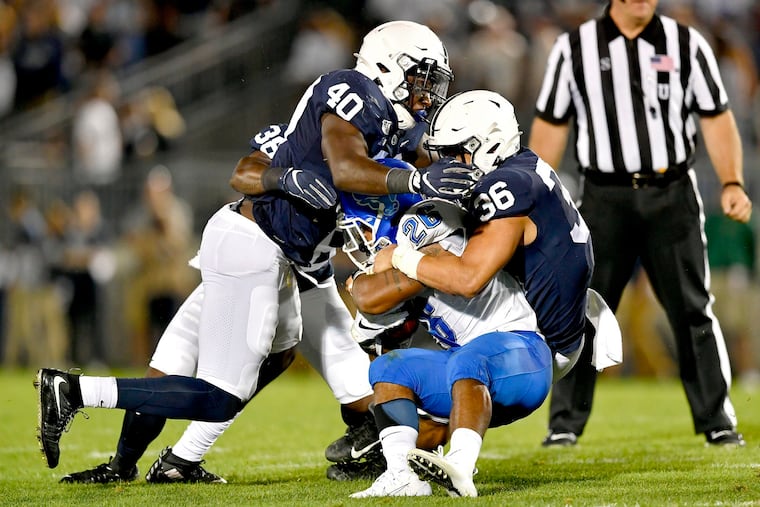 Penn State linebackers Jesse Luketa (40) and Jan Johnson pull down Buffalo's Jaret Patterson in the game on Sept. 7.