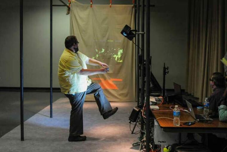 Brad Bartley, senior exhibit designer, tests the prototype of the Body Mechanic Lab baseball exhibit at Art Guild Inc. in West Deptford. The Franklin Institute will house the exhibit at its new SportsZone.