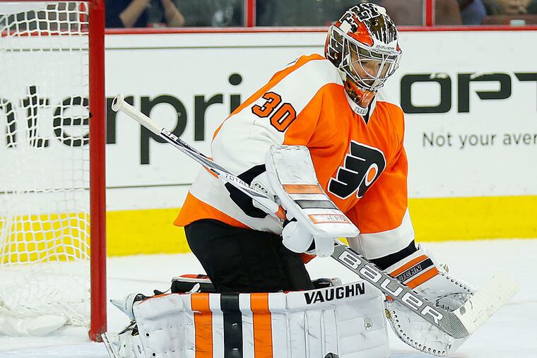 Flyer goalie Michal Neuvirth watches the puck during the second period.
