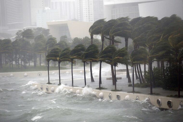 Waves crash over a seawall from Biscayne Bay as Hurricane Irma passes by, Sunday, Sept. 10, 2017, in Miami.