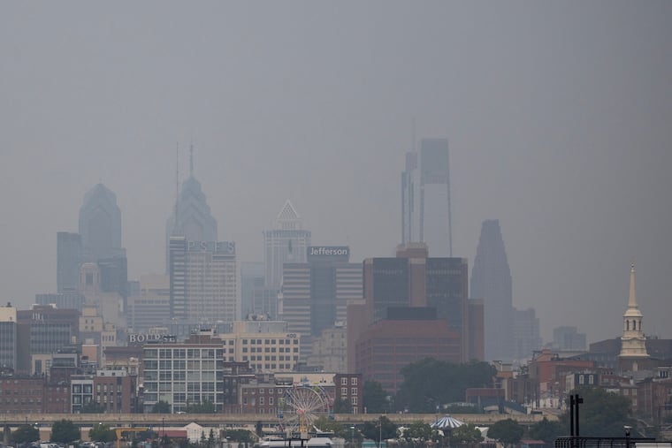 Philadelphia city skyline seen from Camden as the air is filled with smoke from the Canada wild fires in July.