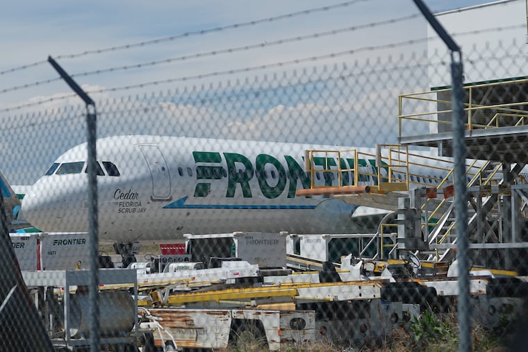 A Frontier Airlines jetliner sits outside the airline's technical operations center with other jetliners in for service north of Denver International Airport Saturday, May 9, 2026, in Denver.