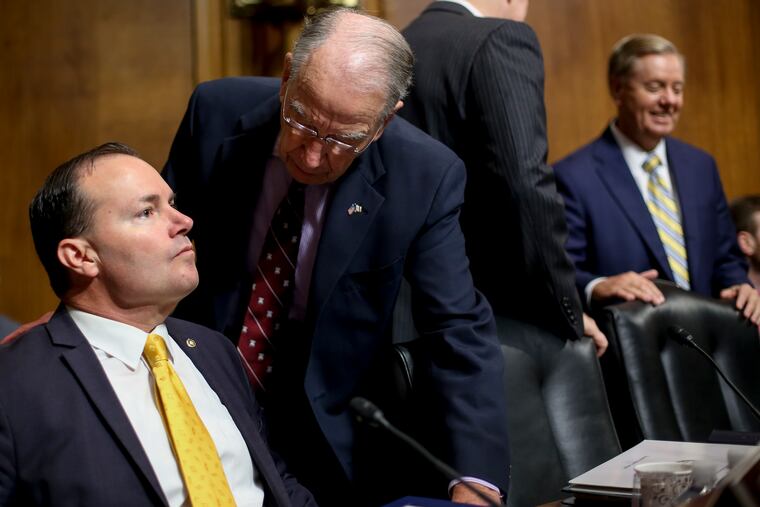 Senate Judiciary Committee Chairman Chuck Grassley of Iowa (second from left) speaks with Sen. Mike Lee, R-Utah (left) before a meeting of the committee last year. Sen. Lee has proposed an act to allow internationally built and operated vessels to engage in trade between U.S. ports.