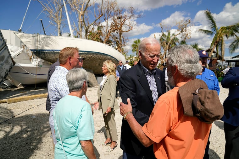 President Joe Biden and first lady Jill Biden talk to people impacted by Hurricane Ian during a tour of the area on Wednesday, Oct. 5, 2022, in Fort Myers Beach, Fla.