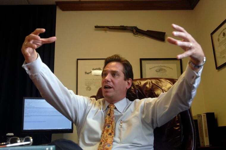 Montgomery County District Attorney Bruce Castor animates a story while being interviewed in his office at the Montgomery County County Courthouse. In the background is one of several handguns and rifles is displayed in his office.