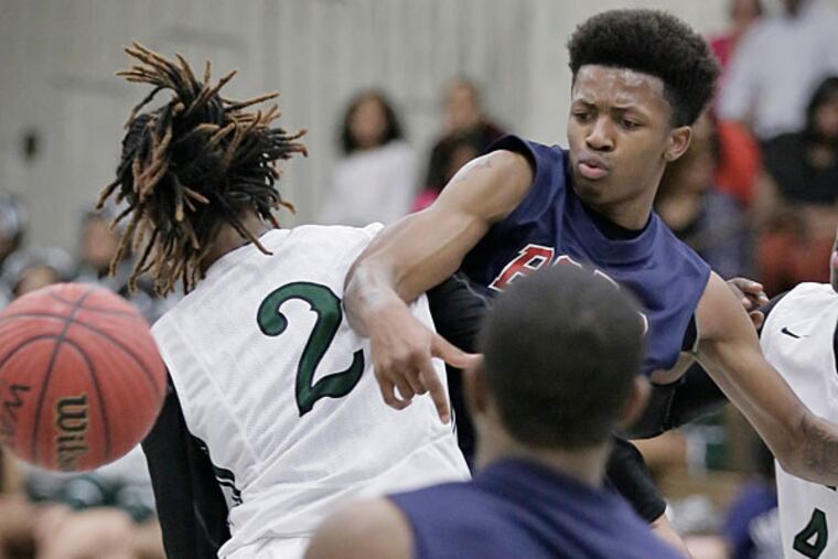 Willingboro's # 3 Bryce Chapman loses the ball when he collides with Pemberton's # 2 Ty'rae Johnson as Pemberton's # 4 DeAngelo Hilton looks on in the 4th quarter of the Willingboro at Pemberton H.S. boys basketball game on January 22, 2015. (Elizabeth Robertson/Staff Photographer)