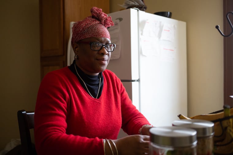 Annie Johnson sits in her home in the Stenton section of Philadelphia Sunday, March 3, 2019. Johnson is a former nanny who hasn't been able to find a nannying job in Philadelphia that she feels pays a decent wage.