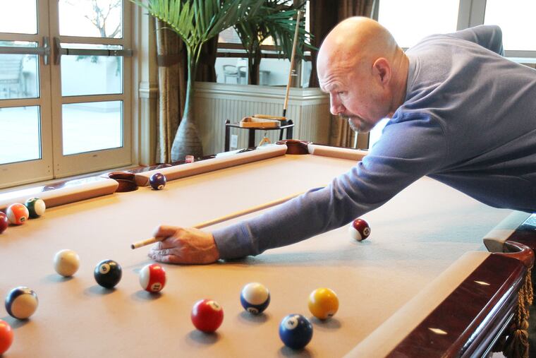 Tony Bruno plays pool at his home at the Dockside Condos in Philadelphia on November 24, 2013. ( DAVID MAIALETTI / Staff Photographer )