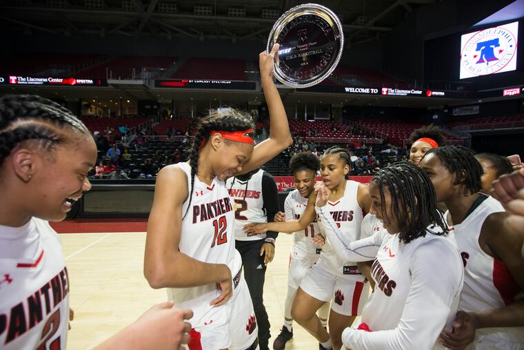 Nadjy Tyler, center, of Imhotep Charter dances after being named the Most Valuable Player in their victory over Audenried in the Girls Public League Championship at the Liacouras Center on Feb.23, 2019.