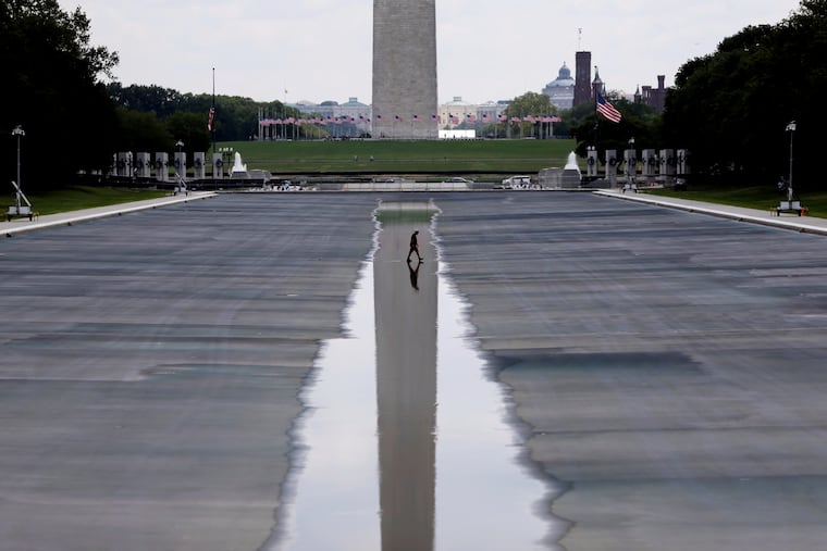 The Washington Monument is seen in the background of the now drained Lincoln Memorial Reflecting Pool, Wednesday, July 29, 2026, in Washington. The president continues to insist it was damaged by vandals despite the absence of evidence.
