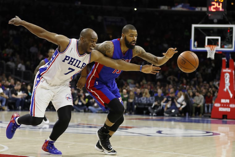 Philadelphia 76ers' Carl Landry (left) and Detroit Pistons' Marcus Morris chase a loose ball.