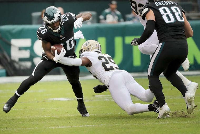 Philadelphia Eagles running back Miles Sanders (26) carries the ball downfield but is brought down by New Orleans Saints cornerback Paulson Adebo (29) during the first quarter Sunday, November 21, 2021 at Lincoln Financial Field in Philadelphia, Pa. on November 21, 2021.