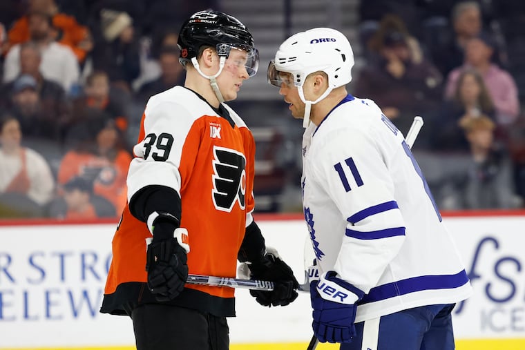 Flyers right wing Matvei Michkov and Toronto Maple Leafs center Max Domi have words after Michkov was called for a interference penalty that caused Maple Leafs defenseman Chris Tanev to leave the game on a stretcher.