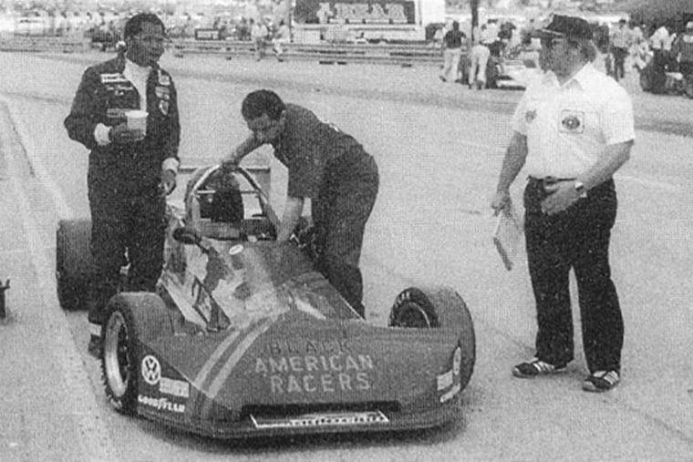 Tommy Thompson (left) looks up the track at the Milwaukee Mile in Wisconsin as Bob Merritt, a friend of Thompson's manager, makes a last-minute adjustment. Two weeks later, Thompson raced at Trenton Speedway and died after a crash, halting his ambition of integrating racing.