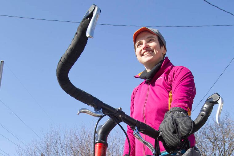 Alison Cohen, a former tennis pro living in Mount Airy, has worked to launch bike shares in NYC, D.C. and Boston. Now, she's in charge of managing Philly's newly announced Indego bike share with her company Bicycle Transit Systems. She is shown in her Mt. Airy neighborhood on Feb. 15, 2015. ( CHARLES FOX / Staff Photographer )