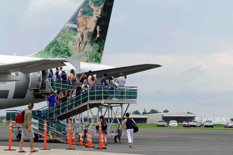 Passengers board a Frontier flight at Trenton-Mercer Airport. Frontier has trimmed some Trenton flights.