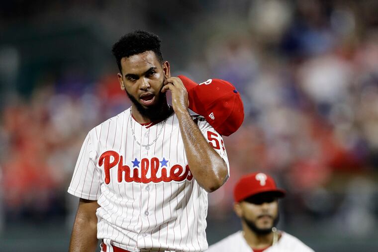 Reliever Seranthony Dominguez removes his hat and glove before being removed by manager Gabe Kapler during the ninth inning of the Phillies' 7-6 loss to the Los Angeles Dodgers at Citizens Bank Park.