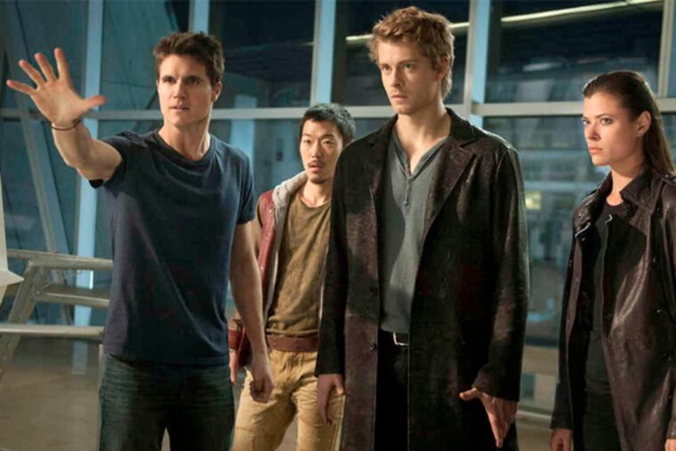 "The Tomorrow People," which premieres Wednesday on the CW, stars (from left) Robbie Amell as Stephen, Aaron Woo as Russell, Luke Mitchell as John, and Peyton List as Cara. (Barbara Nitke / The CW)