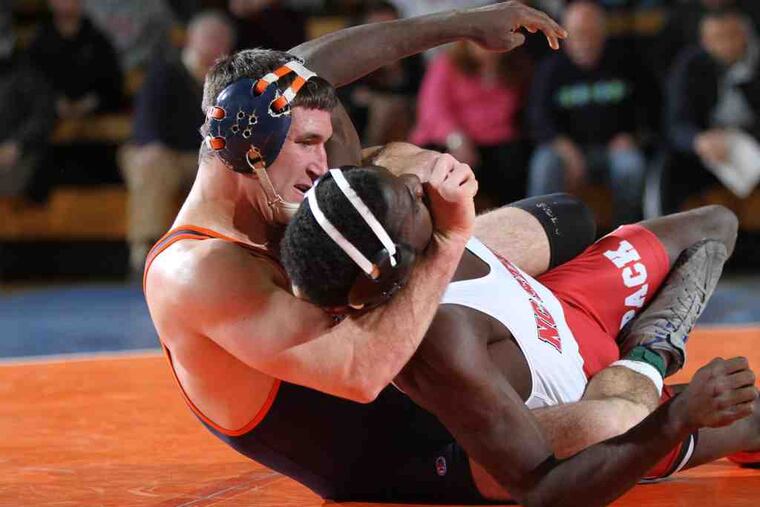 Chris Henrich (left), defeating N.C. State's Nijel Jones, is a graduate of Germantown Academy. He figures to participate in the NCAA Wrestling Championships at the Wells Fargo Center.
