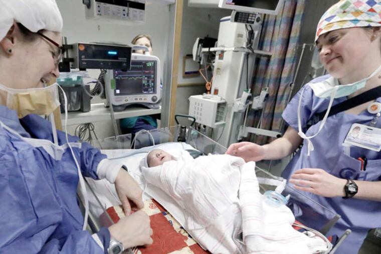 Anesthesiologist Lisa Montenegro and fellow physician Rebecca Evans get Leonardo set up in the neonatal intensive care unit. Surgical outcomes are best when the artery switch is done one to four days after birth, says Jack Rychik, Leonardo's pediatric cardiologist. The baby's prognosis is good, he says.
