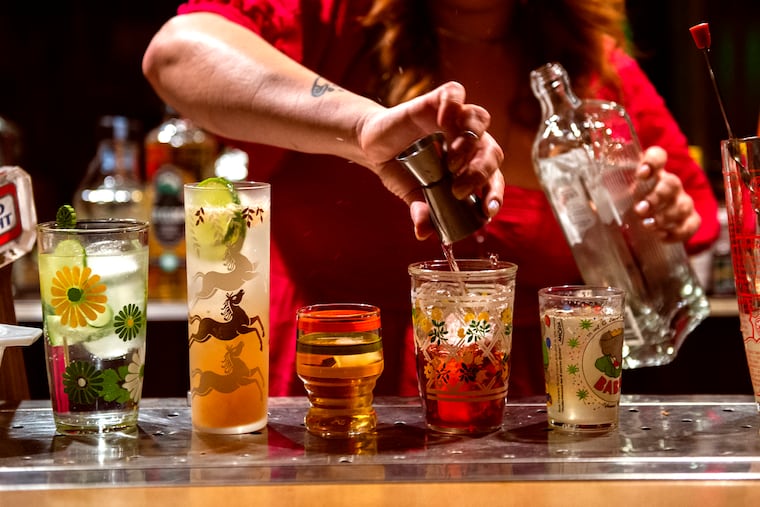 Chelsea Campbell, 37, makes an array of drinks in her basement bar. The space was featured on South Philly Time Capsules, an Instagram account that highlights the neighborhood's vintage touches.