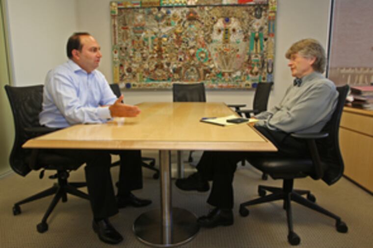 Sheldon Bonovitz (right), chairman and chief executive officer at Duane Morris, has a meeting with partner Richard Silven.