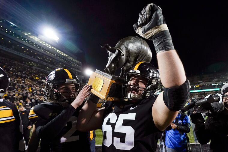 Iowa center Tyler Linderbaum (65) is a projected top-10 selection but could be a possible successor to Jason Kelce if the Eagles are willing to spend their draft capital on the offensive line early.
carries the Floyd of Rosedale trophy off the field after an NCAA college football game against Minnesota, Saturday, Nov. 13, 2021, in Iowa City, Iowa. Iowa won 27-24. (AP Photo/Charlie Neibergall)