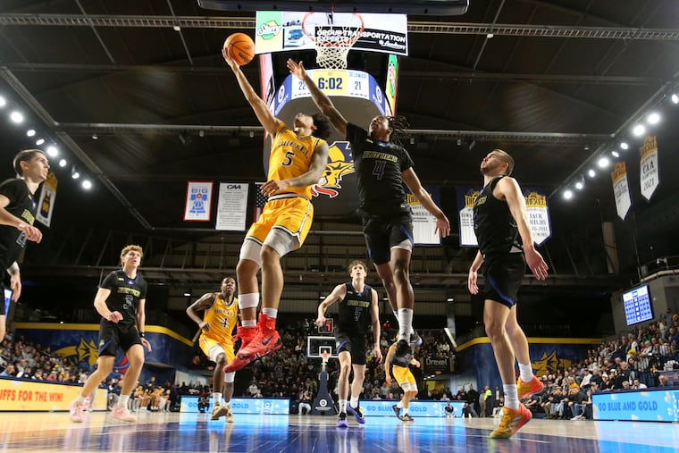 Kobe MaGee of Drexel scores on a reverse layup against Niels Lane of Delaware on Jan. 25.