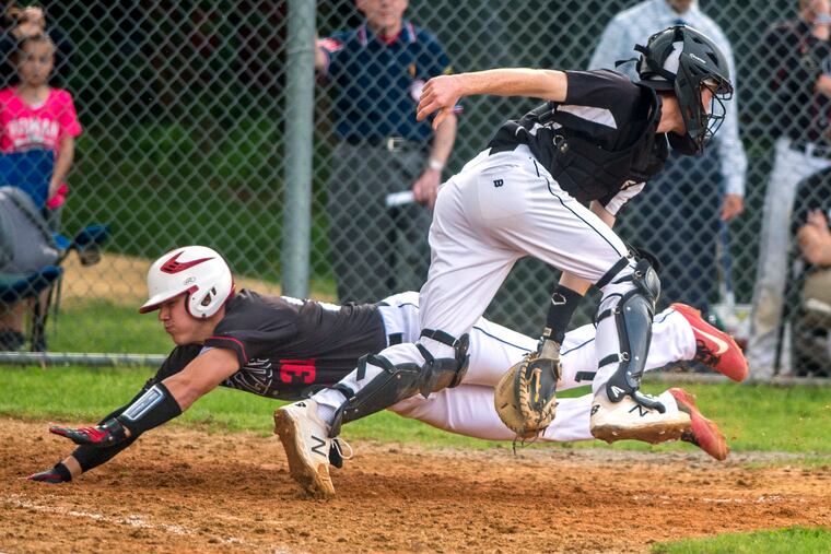 Haddonfield's Chris Brown is safe diving into home plate past Moorestown catcher Nick Yedman to score during Haddonfield's victory in the first round of the Diamond Classic.