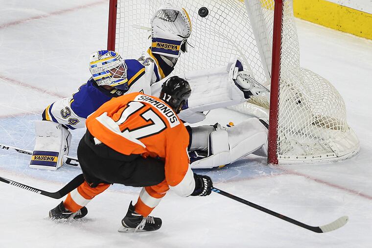 Wayne Simmonds score a shorthanded goal on the Blues' goalie Jake
Allen.