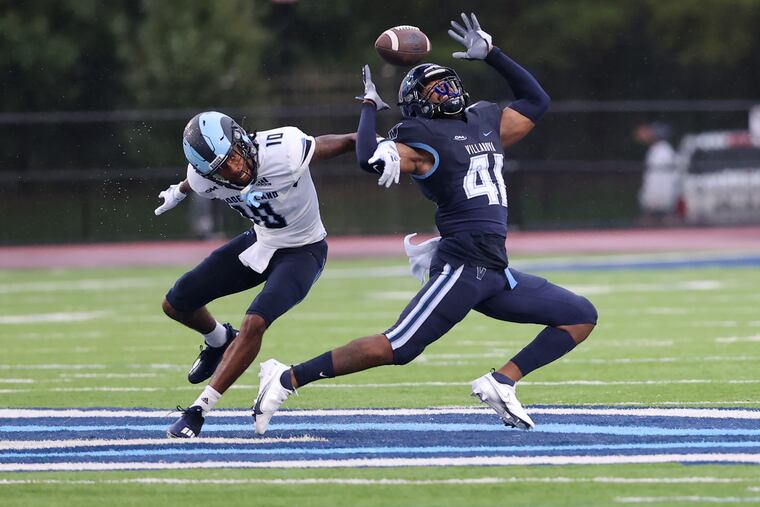 Christian Benford, right, of Villanova intercepts a pass intended for Paul Woods of Rhode Island during the 2nd half on Oct. 23, 2021 at Villanova University.