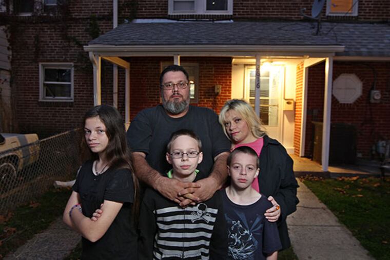 Left to right, front row Sierra Quintiliani, 13, Dylan Blue, 12, and Zachary Blue, 11, live with their mother Melissa Zirilli, back right, and her husband, Donald Grover, in a rented house in Chester, PA. (MICHAEL BRYANT / Staff Photographer )