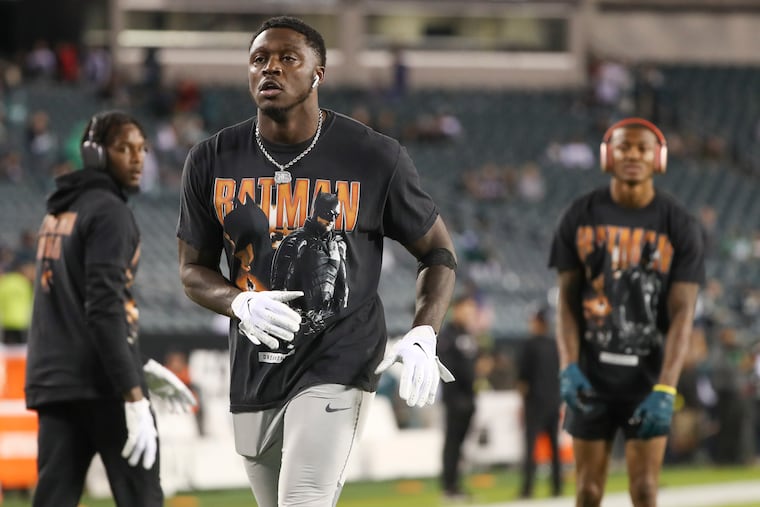 A.J. Brown (center) wears a Batman shirt along with fellow Eagles wide receivers Quez Watkins (left) and DeVonta Smith while warming up before a 2022 game against the Dallas Cowboys.