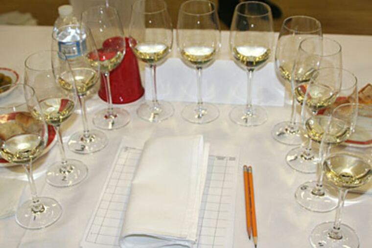 Tools of the judging trade: Olives, water, sourdough bread for keeping the palate fresh - "Sometimes I lick my napkin," confided one judge - and a bucket for spitting. (Craig LaBan / Staff)
