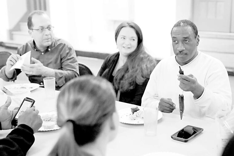 Dining at the Student-Run Emergency Housing Unit of Philadelphia are Steve EauClaire (left) and Joanie Mazelis, with ex-resident Dennis Enoch. Twins Amelia and Sam donated to the shelter in lieu of gifts for their seventh birthday.